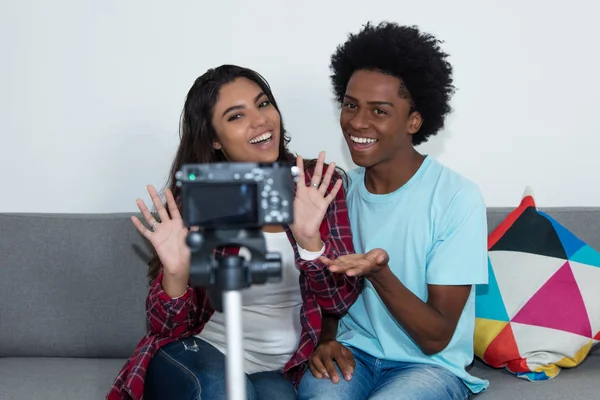 African american vlogger and influencer girl recording video blog with camera at home